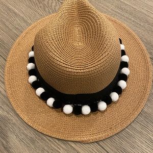 Women’s beach or sun hat decorated with Pom poms